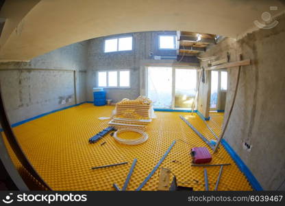 yellow underfloor heating posed in a under construction building