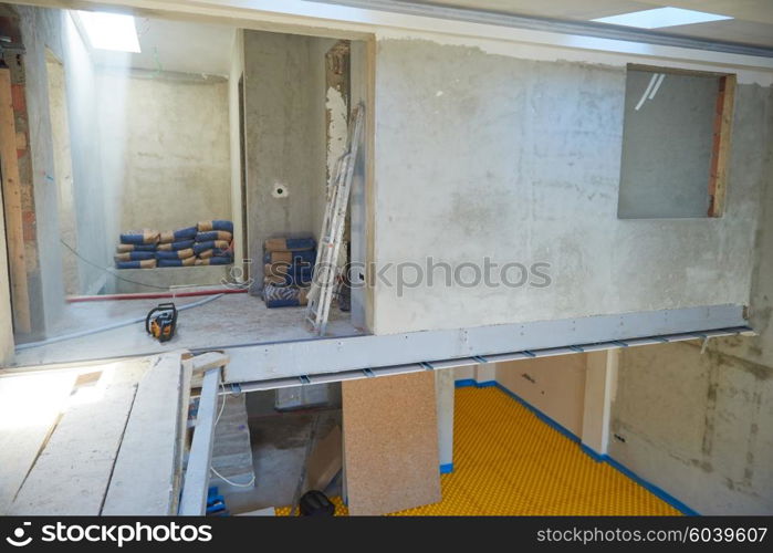 yellow underfloor heating posed in a under construction building