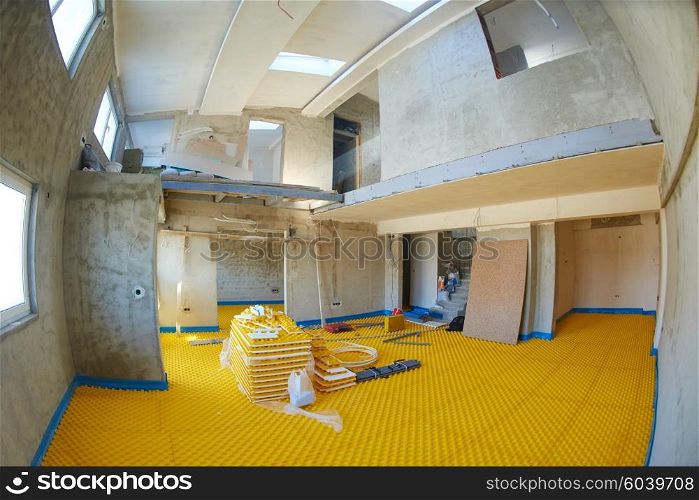 yellow underfloor heating posed in a under construction building