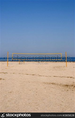 Yellow volleyball net on beach