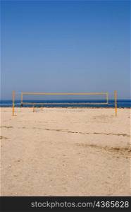 Yellow volleyball net on beach