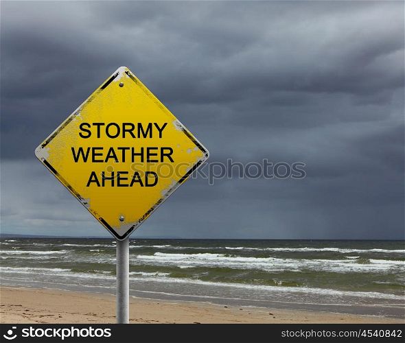 yellow warning sign of bad weather ahead against stormy sky