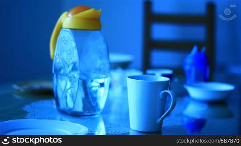 Yellow water jar and dishes on the table