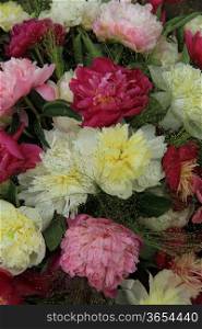 yellow white and pink peonies in a wedding arrangement