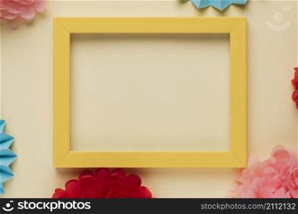 yellow wooden border picture frame with decorated origami flowers