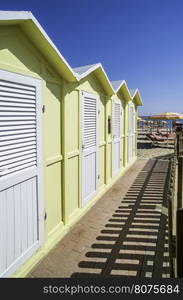 Yellow wooden cabins on the beach.