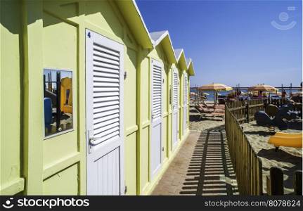 Yellow wooden cabins on the beach.
