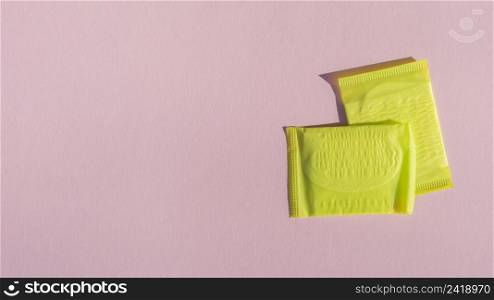 yellow wrapped pads with pink copy space background