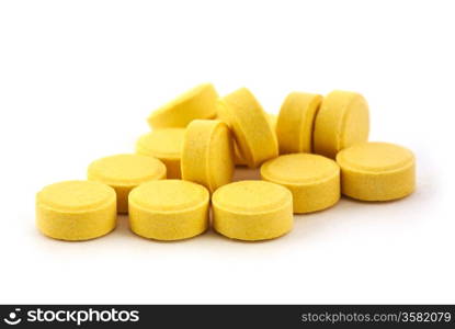 Yelow pills isolated on white