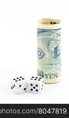 Yen currency stands next to pair of dice on white background in vertical image with copy space. Metaphor reflects concept of challenges and risks in Japan.