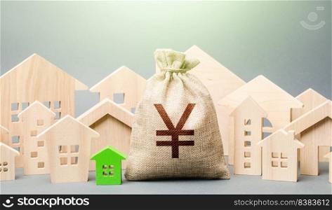 Yen Yuan money bag and a city of house figures. Buying real estate, fair price. City municipal budget. Development and renovation of buildings. Investments. Cost of living in town. Property tax.