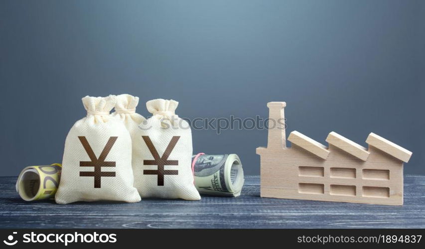 Yen Yuan money bags and industrial factory plant. Investments in production and energy industry. Subsidies and support for businesses. Concession auction tender. Budget-forming subjects of the economy