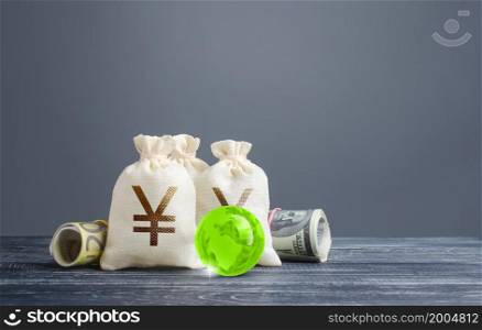 Yen yuan money bags. Banking financial system, world reserve currency. Economics, lending business. Dividends payouts. Investing in economy, replenishing budget with taxes. Trading, currency exchange