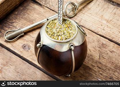 Yerba mate in calabash and dry herb.Traditional argentinian beverage. Yerba mate tea in a calabash gourd