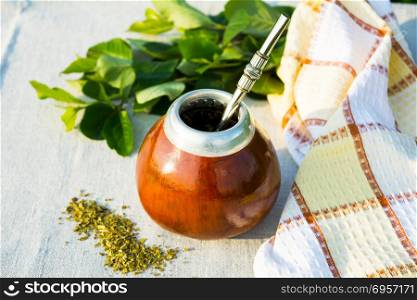 Yerba mate in gourd calabash with bombilla. Yerba mate in gourd calabash with bombilla. Traditional Latin America herbal tea in mate calabash with special mate drinking straw bombilla.
