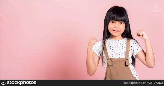 Yes   Asian little kid 10 years old celebrating great success with arms raised at studio shot isolated on pink background, Happy and excited child girl positive smiling cheerful