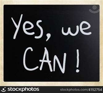 ""Yes, we can!" handwritten with white chalk on a blackboard"