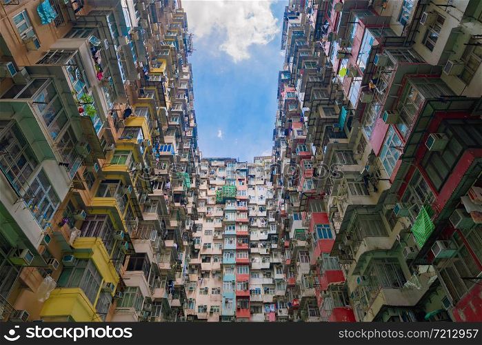 Yick Fat Building, Quarry Bay, Hong Kong Downtown. Residential area in old crowded apartments. High-rise building, skyscraper with facade windows of architecture in urban city at noon with blue sky.