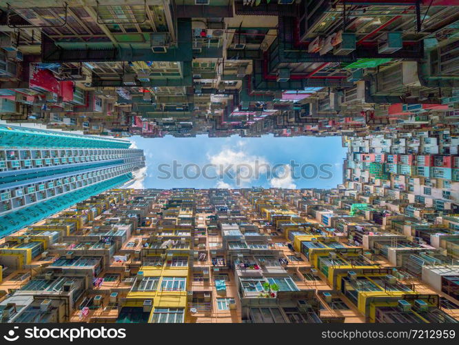 Yick Fat Building, Quarry Bay, Hong Kong Downtown. Residential area in old crowded apartments. High-rise building, skyscraper with facade windows of architecture in urban city at noon with blue sky.