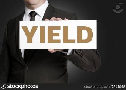 yield sign held by businessman concept.. yield sign held by businessman concept