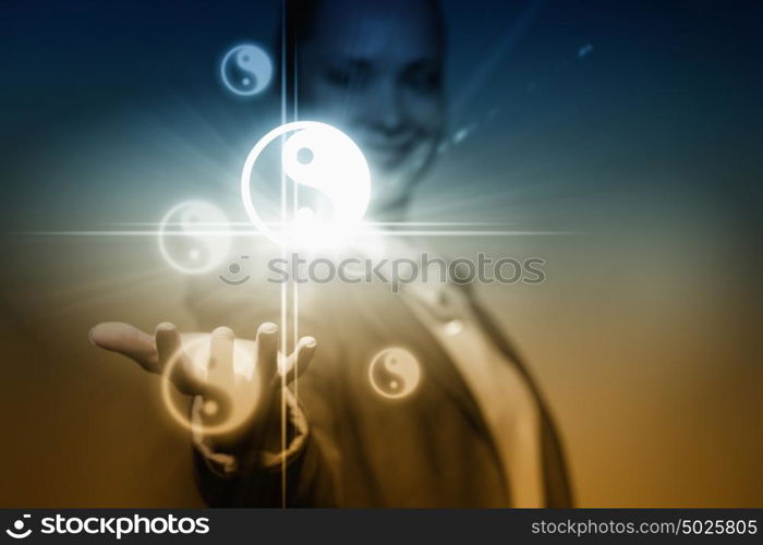 Yin yang concept. Young businesswoman holding yin yang symbols in palm