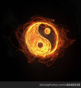 Yin Yang sign. Glowing light Yin Yang sign in fire on dark background