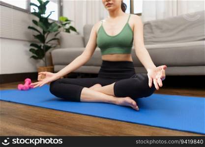 Yoga and wellness concept, Young Asian woman doing yoga with meditation in padmasana or lotus pose.