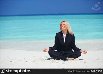 yoga business woman in lotus pose on the beach