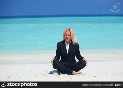 yoga business woman in lotus pose on the beach