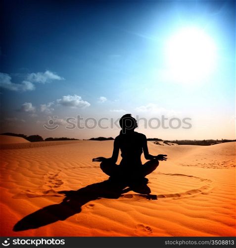yoga girl in the heart sign on desert sand