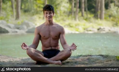 Yoga, meditation and health, young man smiling during lotus position. Part 4 of 7
