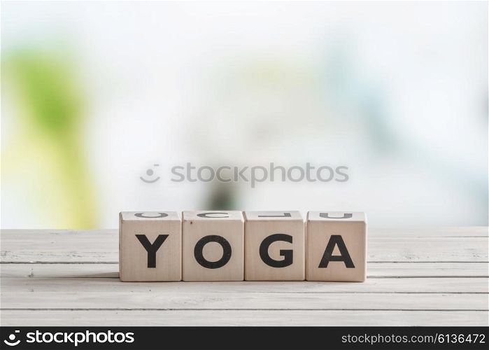 Yoga sign made of cubes on a wooden desk