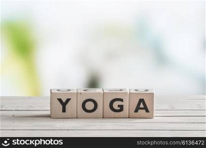 Yoga sign made of cubes on a wooden desk