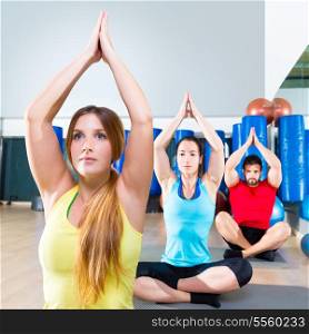 Yoga training exercise in fitness gym people group relaxed hands up