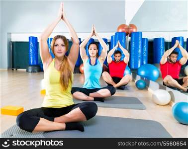 Yoga training exercise in fitness gym people group relaxed hands up