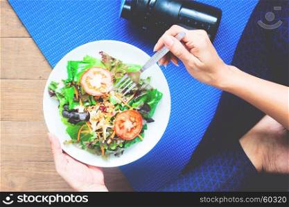 Yoga woman eating fresh salad, Fitness and Healthy concept