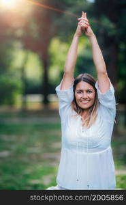 Yoga woman, grounding in nature, tree pose, green background.. Yoga Tree Pose.