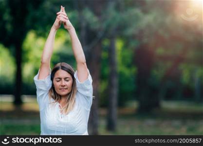 Yoga woman, grounding in nature, tree pose, green background.. Yoga Tree Pose.
