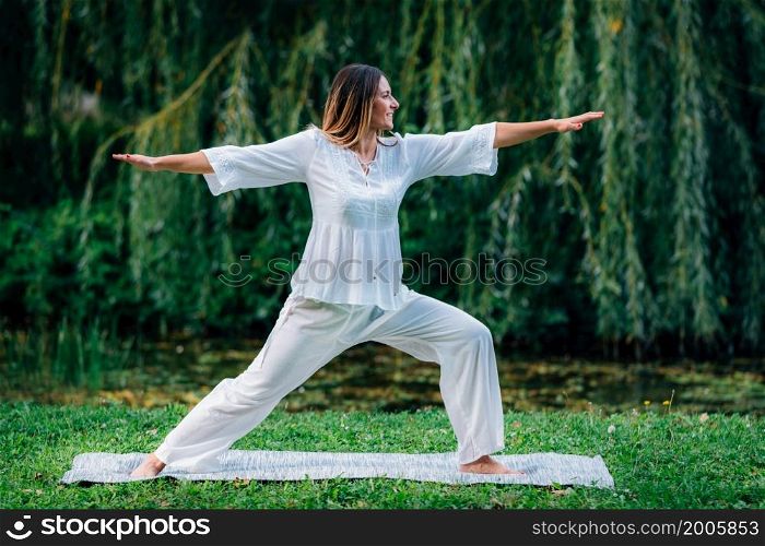 Yoga Woman in Nature. Warrior Pose.