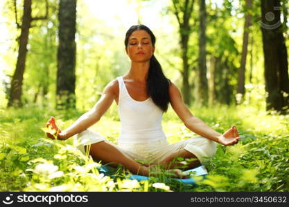 yoga woman on green grass in forest