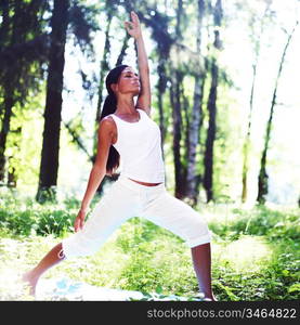 yoga woman on green park background