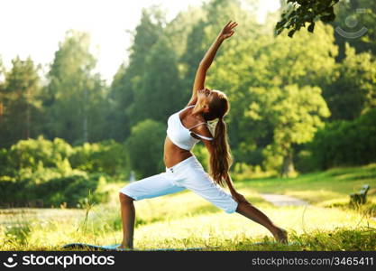 yoga woman on green park background