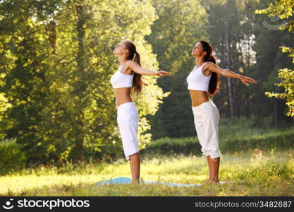 yoga woman on green park background