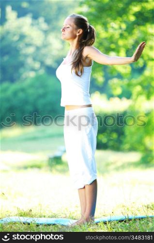 yoga woman on green park background