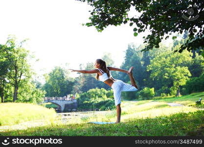 yoga woman on green park background