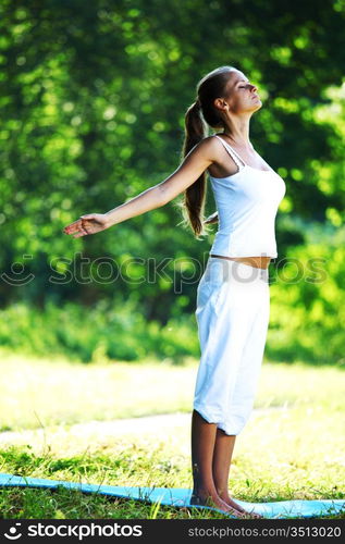 yoga woman on green park background