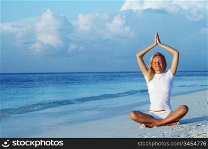 yoga woman on sea coast