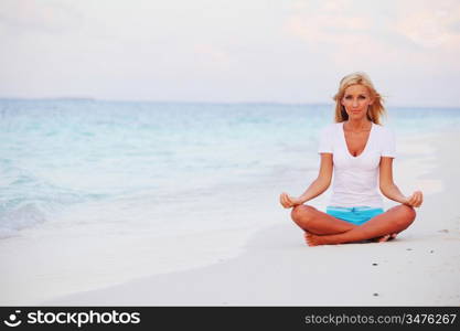 yoga woman on sea coast