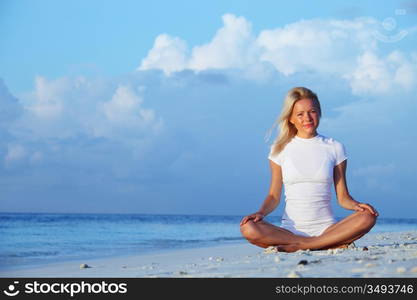 yoga woman on sea coast