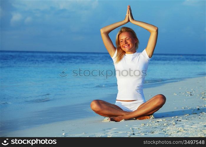 yoga woman on sea coast